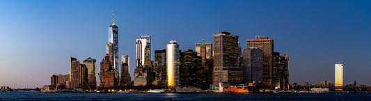 Lower Manhattan contrasting panorama at sunset with sun reflections on buidings.jpg