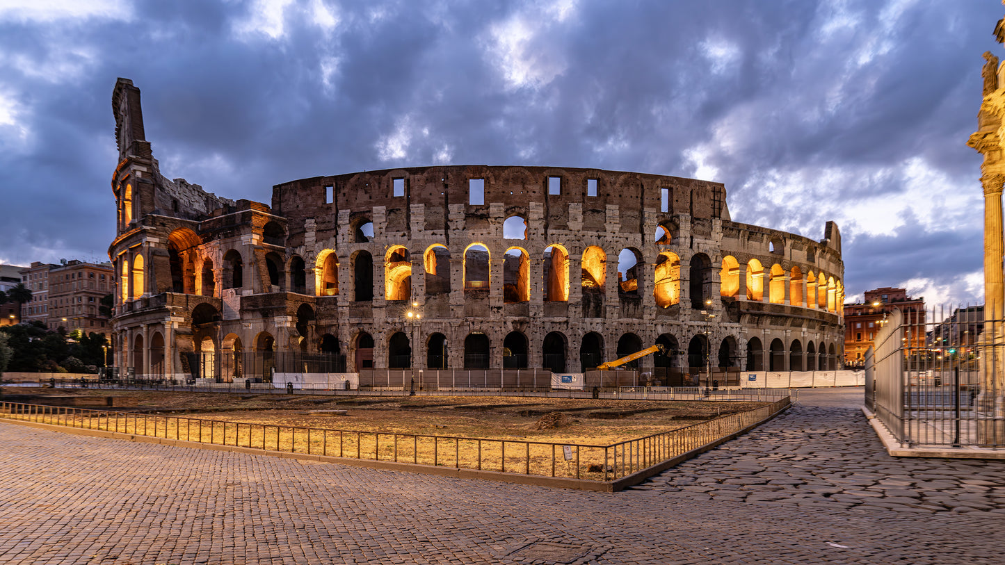 Dark skies, illuminated arches - Colosseum